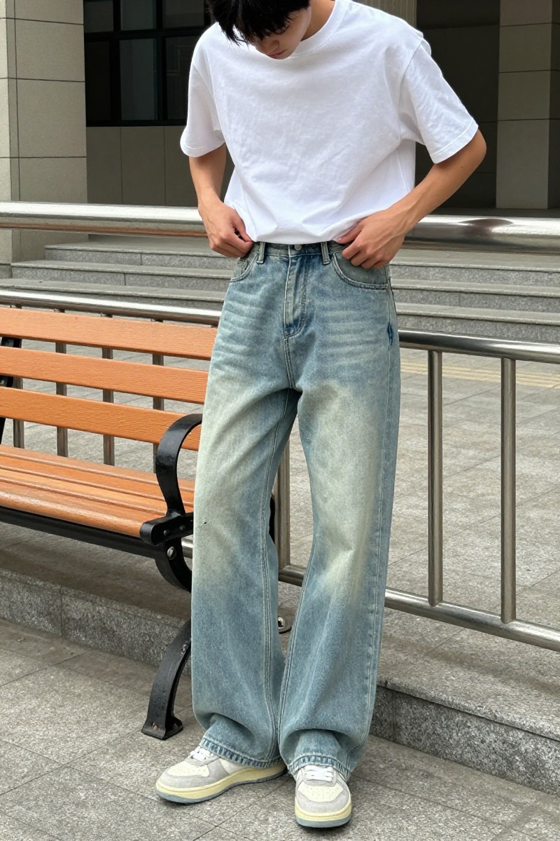 Relaxed light-wash denim image used to explain how slim belts connect with wider trousers