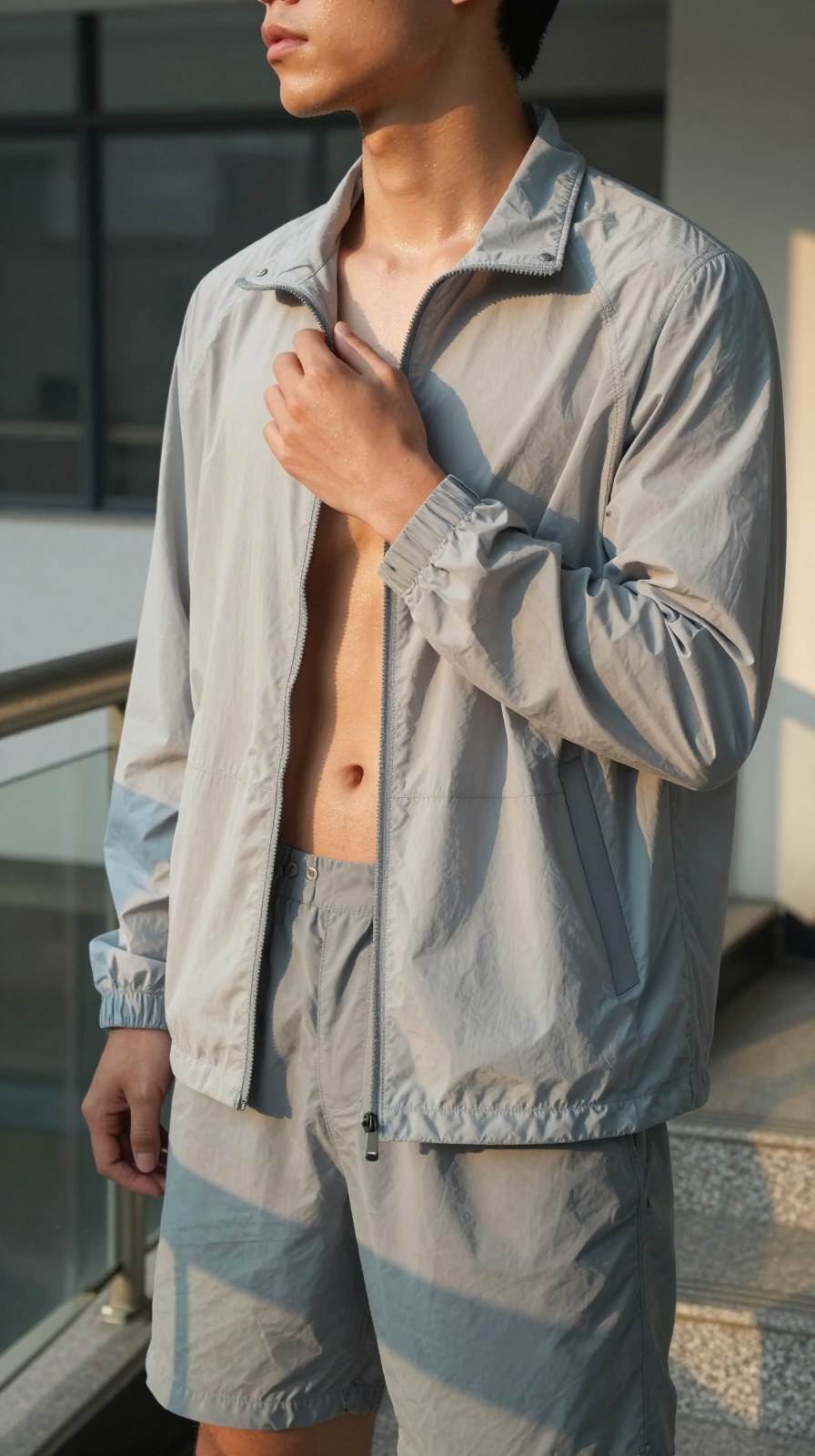 A close view of a light outer layer collar and placket, useful for explaining spring-summer nylon coach jacket structure